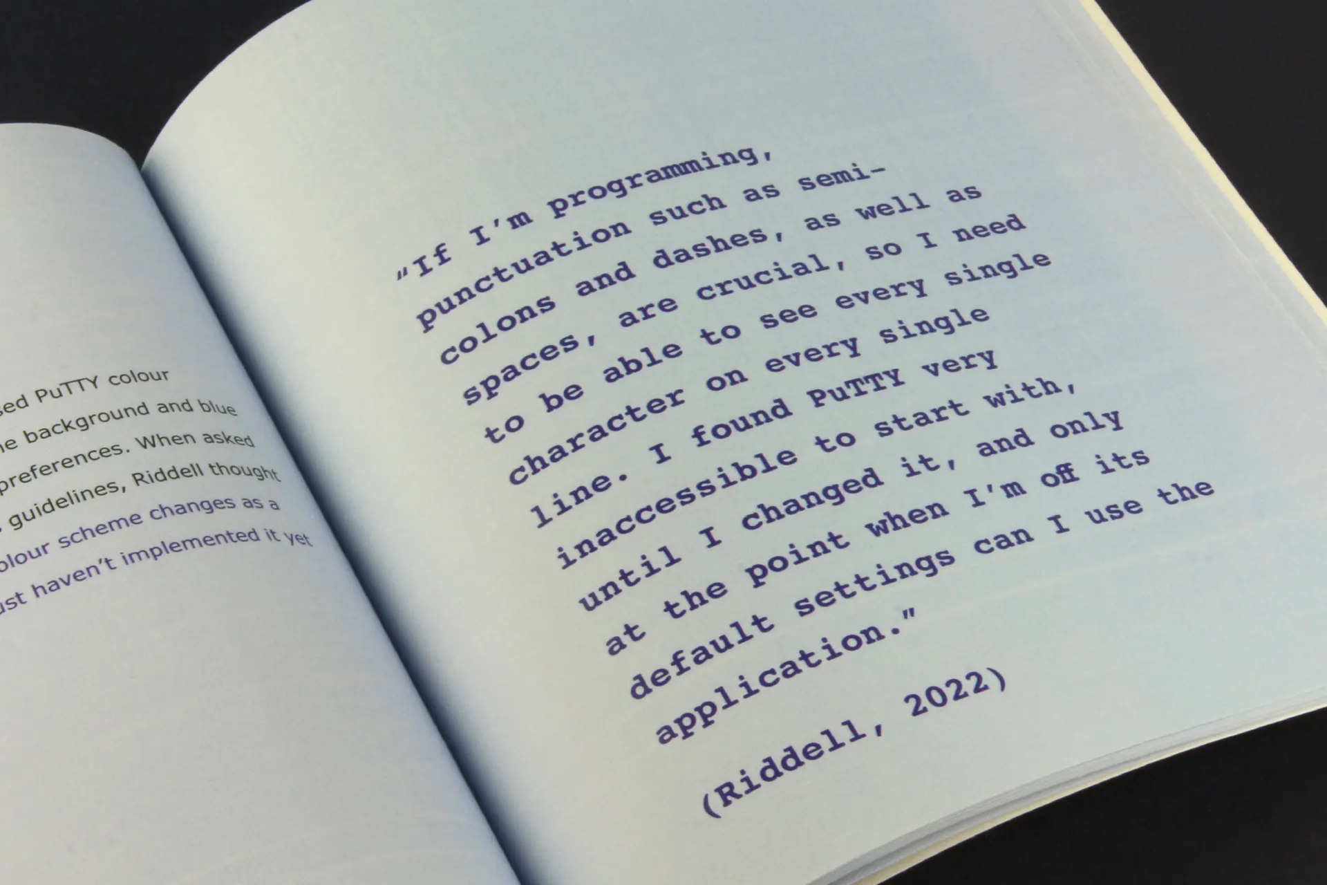 Close-up of a page from the dissertation with a quote on light blue paper
