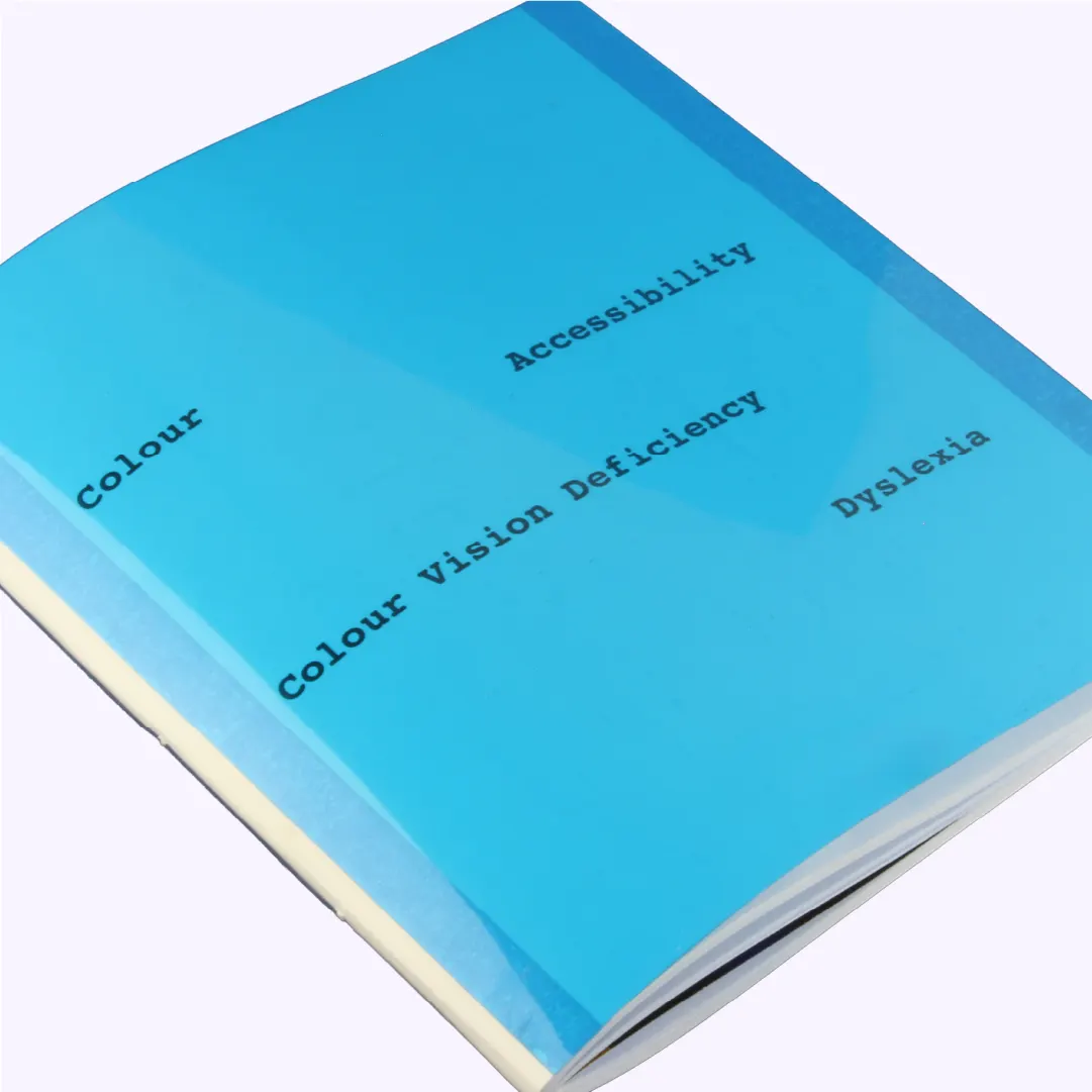 Dissertation cover with blue dyslexia-overlay acetate and printed words 'colour, accessibility, colour vision deficiency, dyslexia'