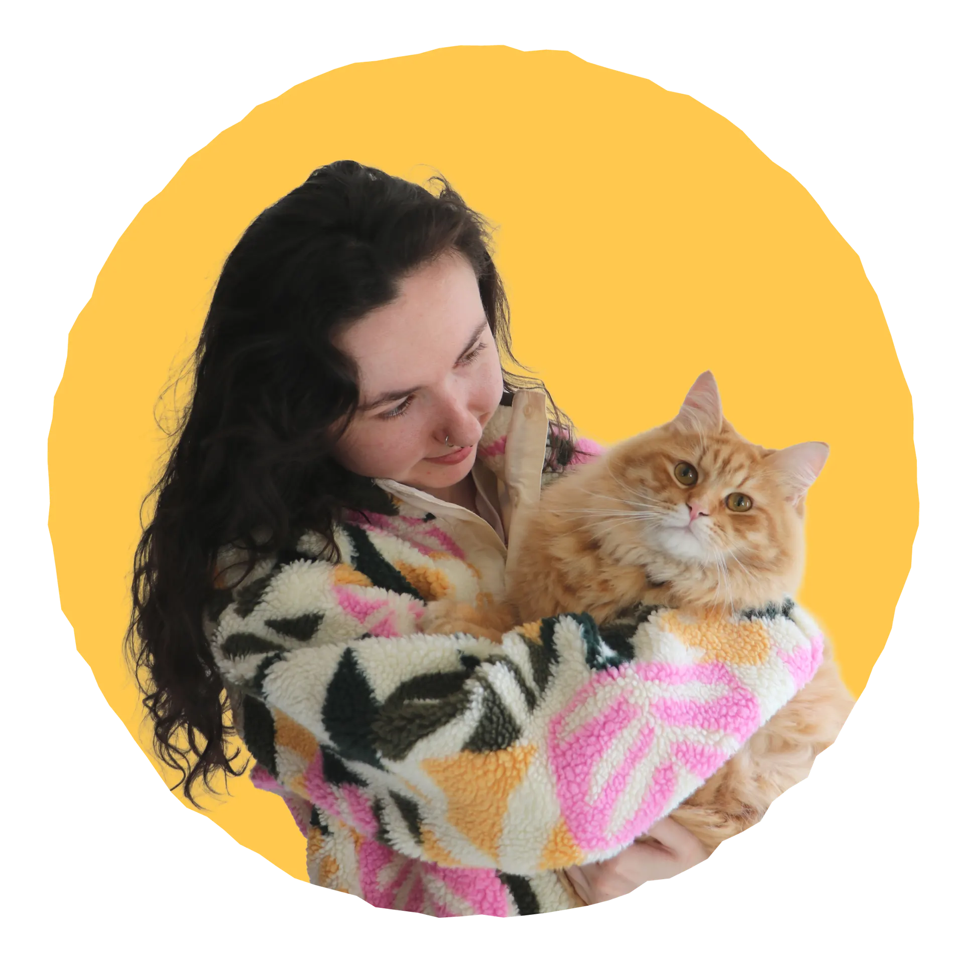 Orla, freelance graphic designer and illustrator, holding her cat